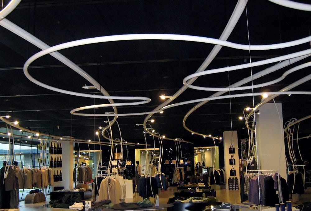 Metal tubular ceiling structure with powder coated finish and integrated light fixtures